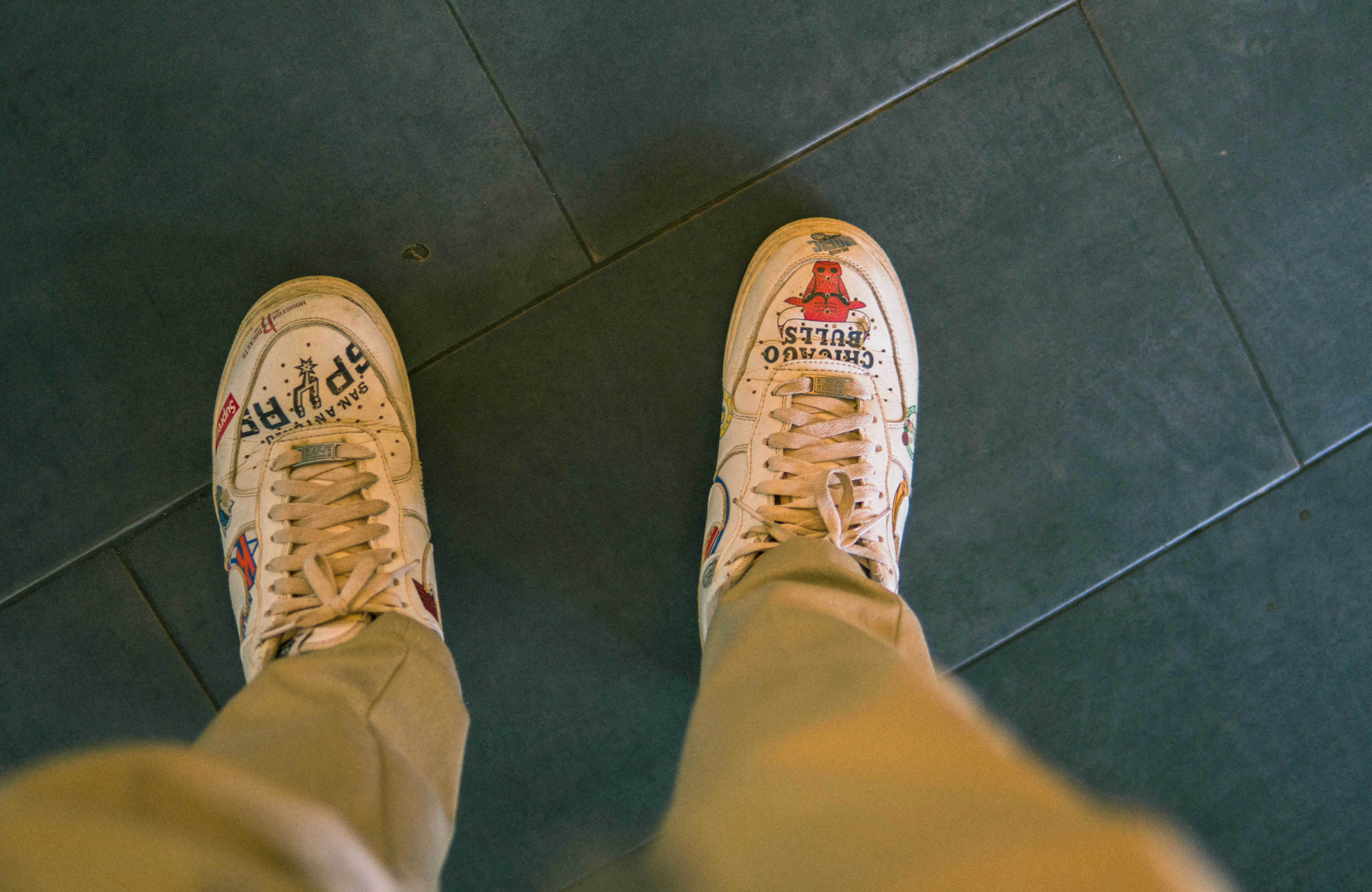 person in blue pants wearing gray and white sneakers