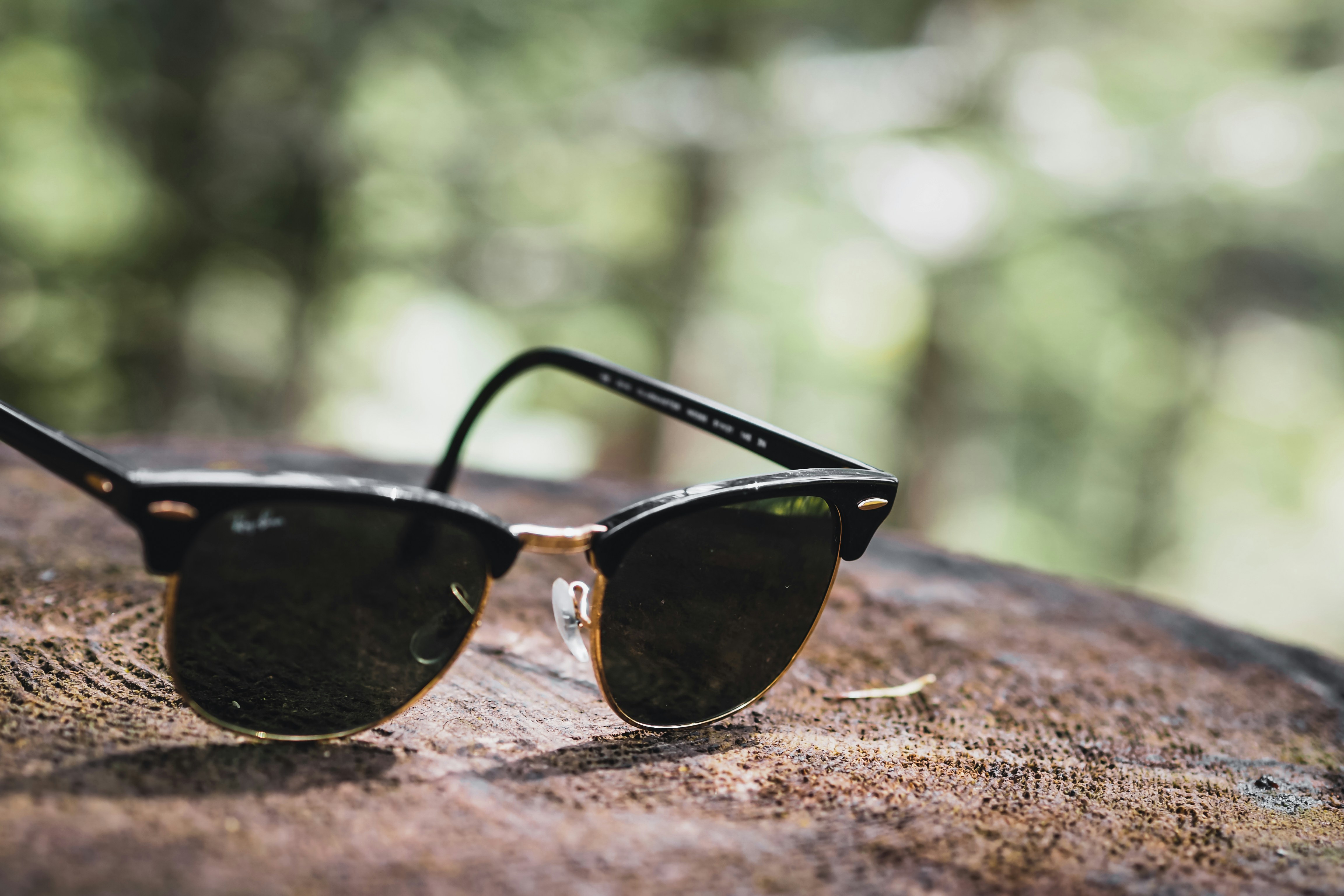 black framed sunglasses on brown wooden table