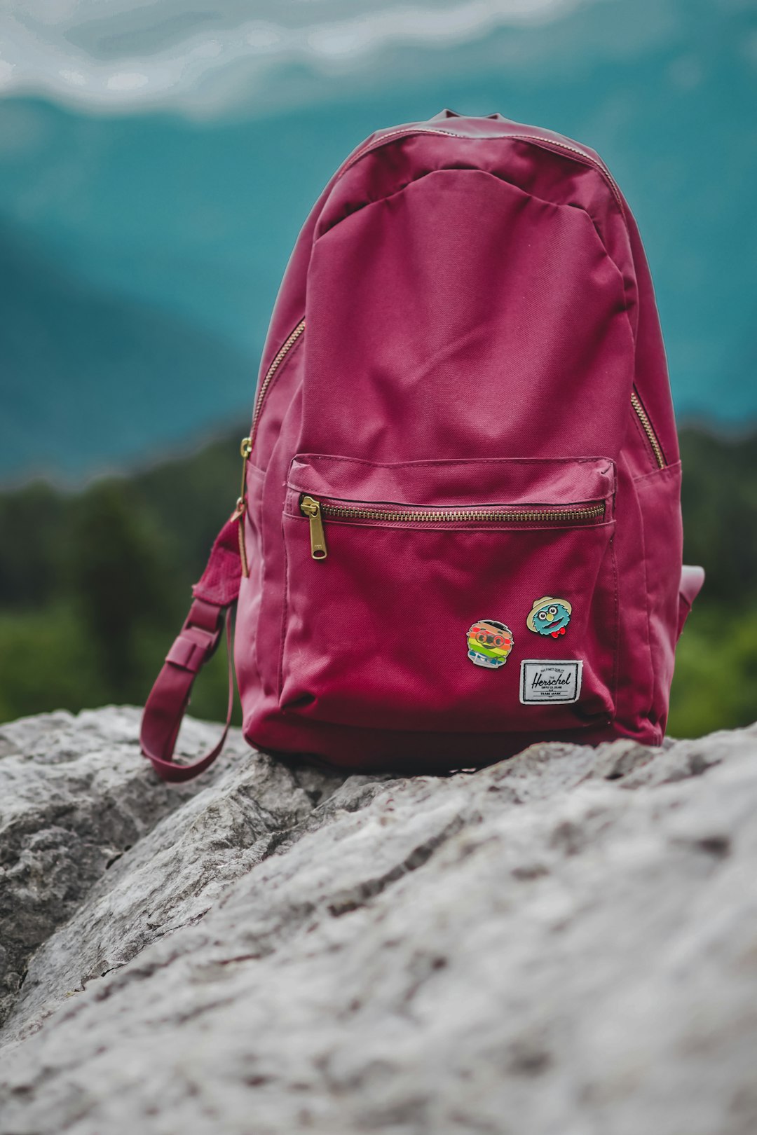 red and black backpack on gray rock