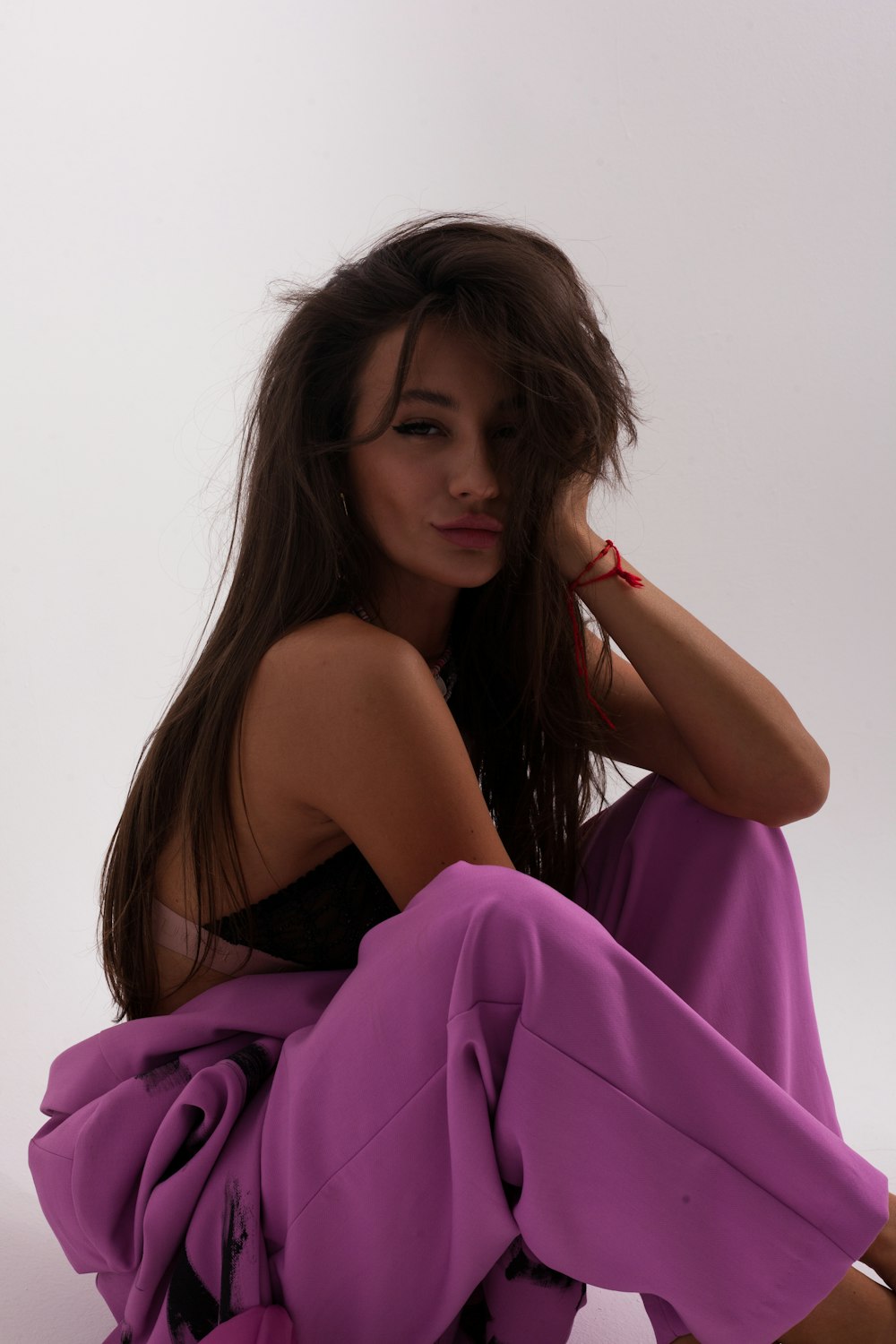 woman in purple dress holding her hair