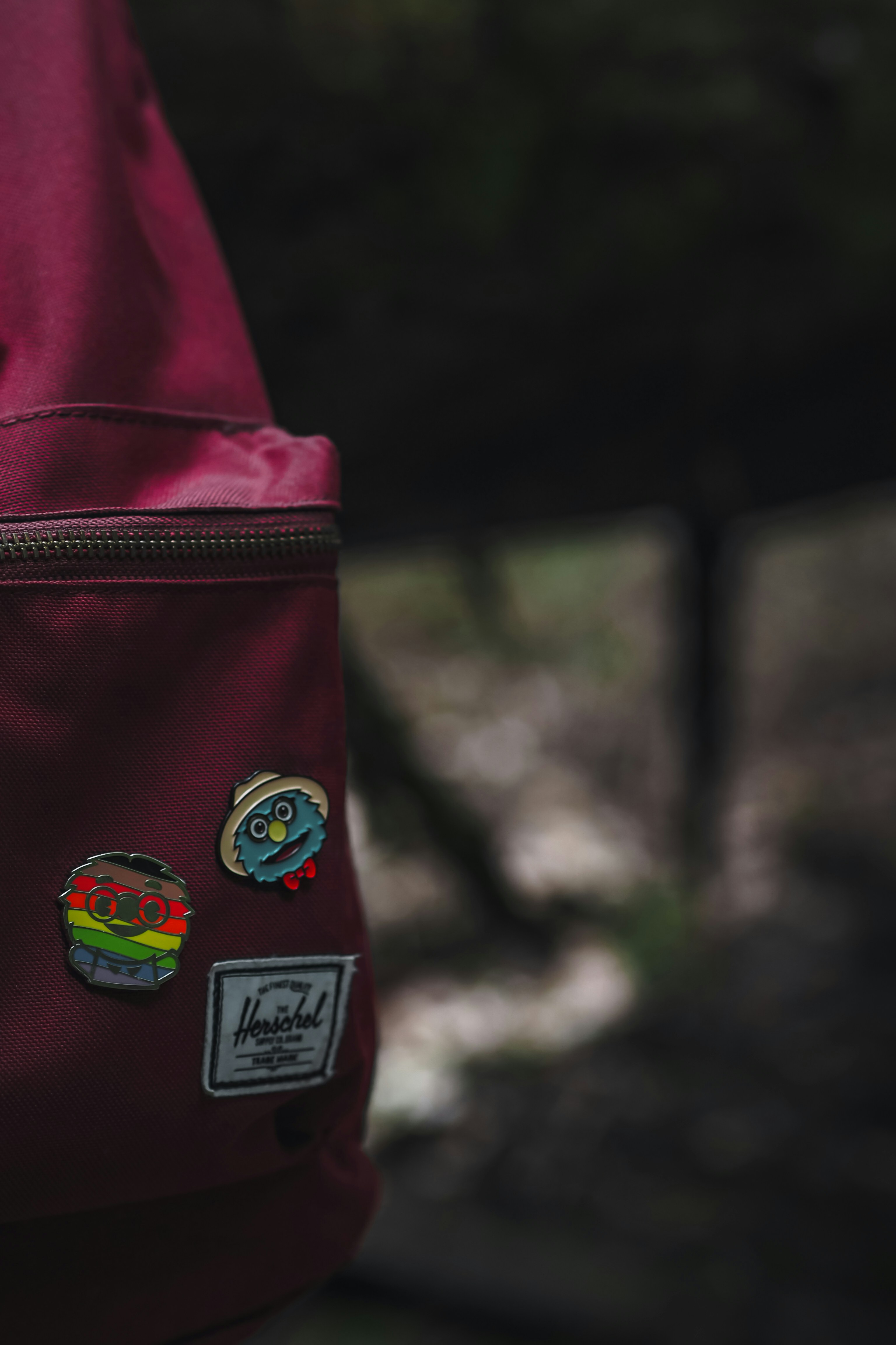 red and black backpack with green and yellow sticker