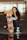 woman in blue tank top holding orange and black skateboard