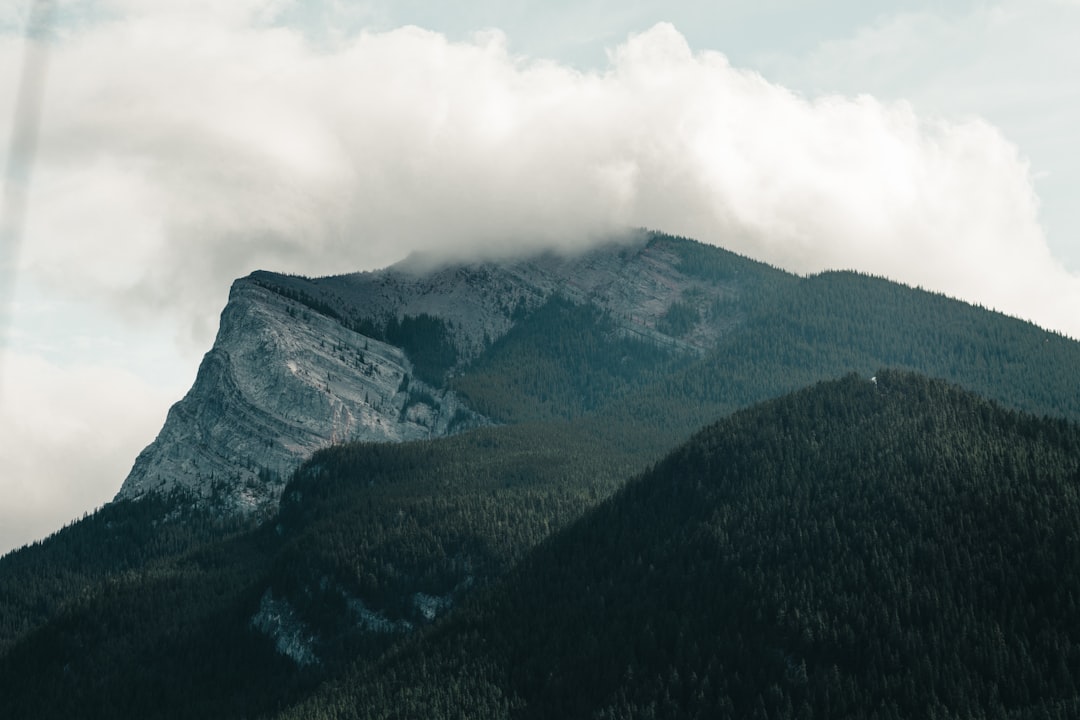 green and gray mountain under white clouds during daytime