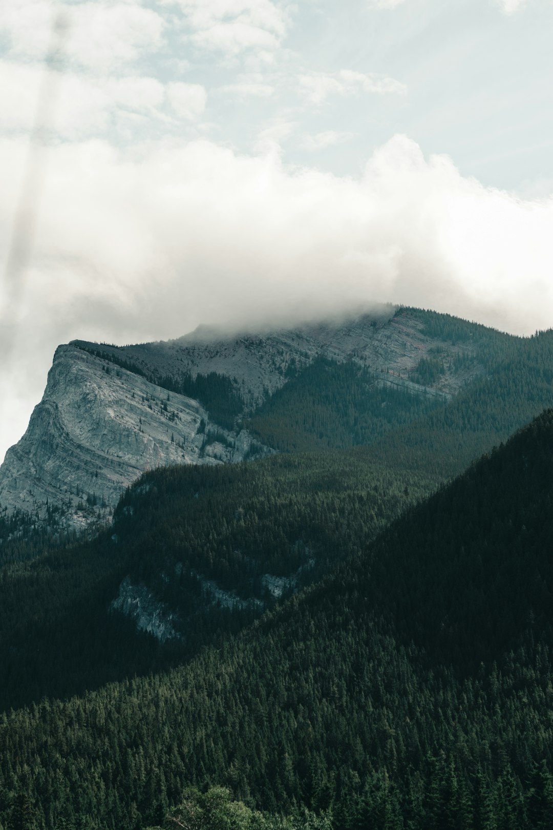 green and black mountain under white clouds during daytime