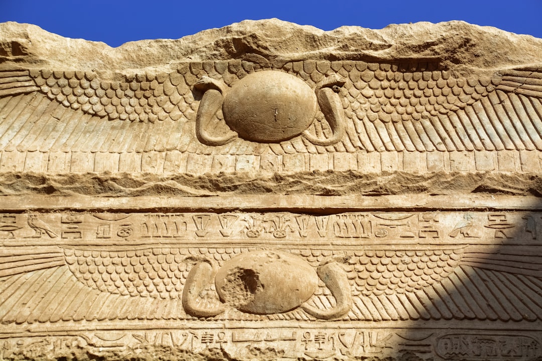 brown concrete wall with human face carved