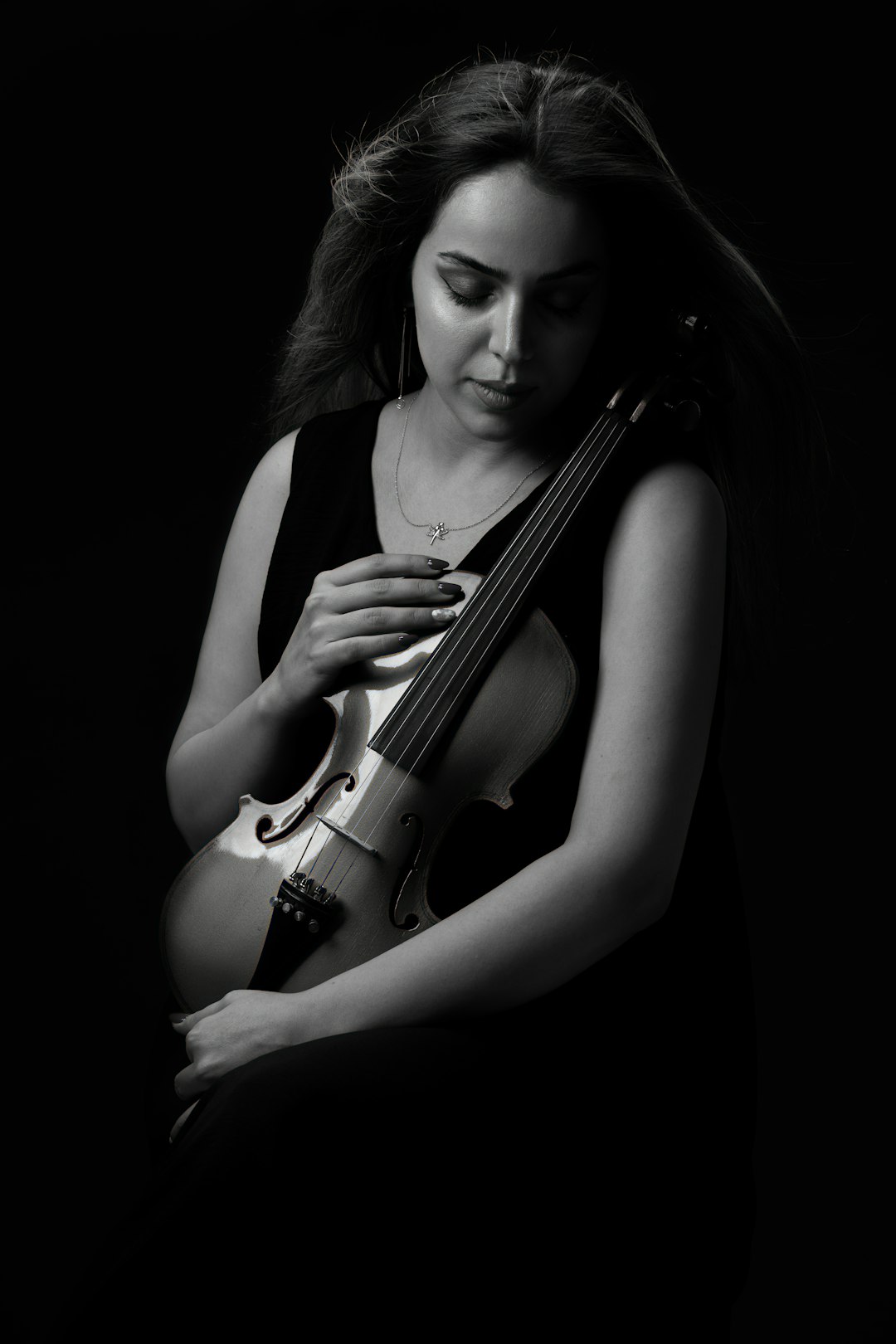 woman in black tank top holding violin