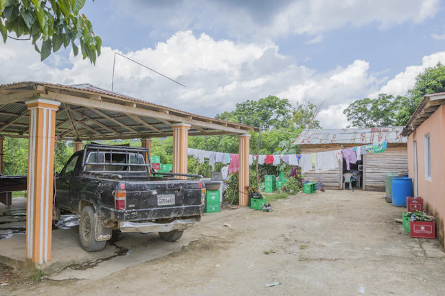Laundry pickup van parked outside a family house in the Houston area on a sunny day.
