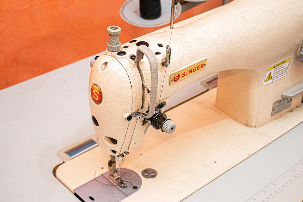 white sewing machine on white table