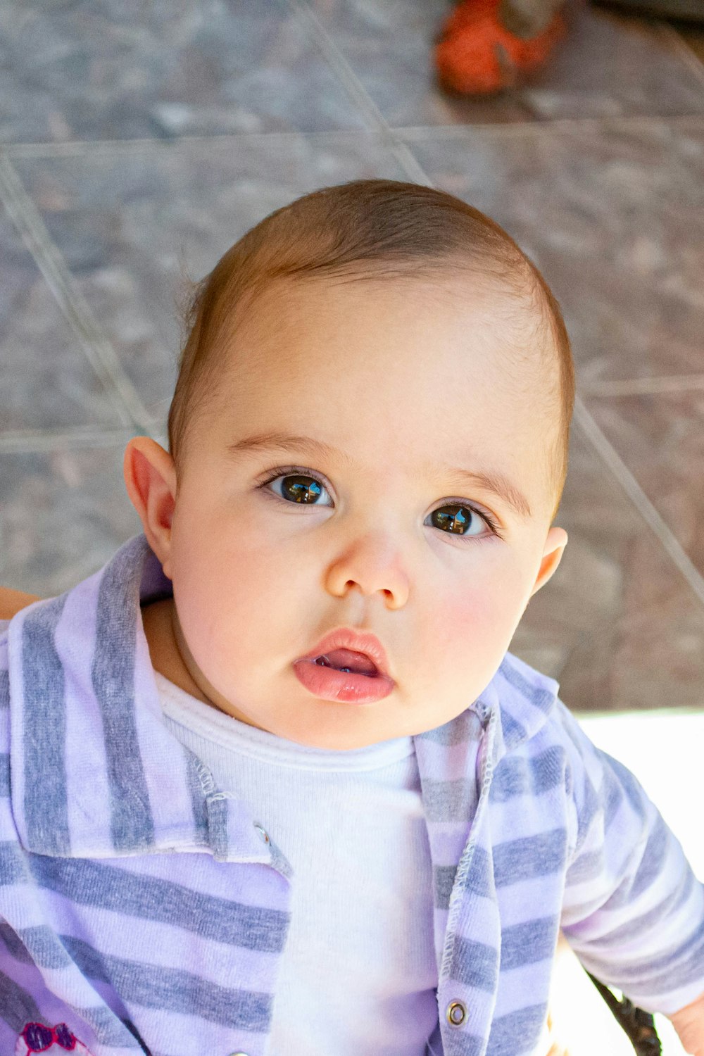 baby in white and blue stripe shirt