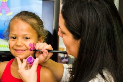 woman in red tank top holding pen