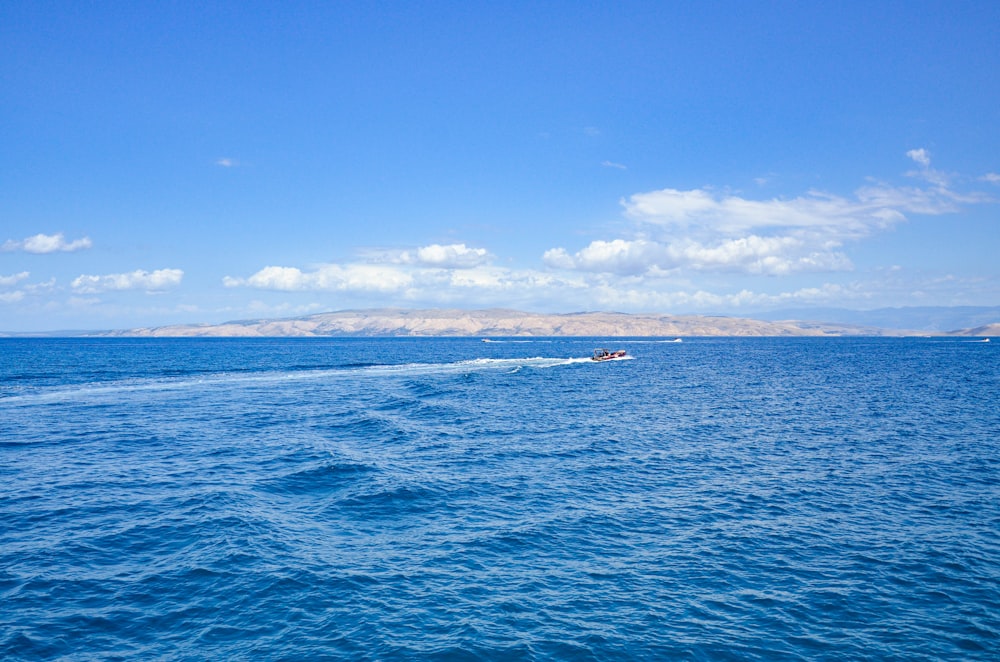 people riding on boat on sea during daytime