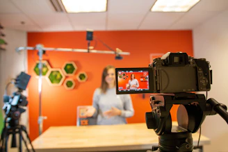 black video camera on brown wooden table