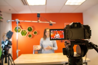 black video camera on brown wooden table