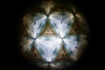 A user’s saved kaleidoscope pattern displayed on a tablet with a sharing icon visible.