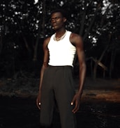 A model wearing sustainable clothing in a natural setting.