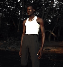 A model wearing sustainable clothing in a natural setting.