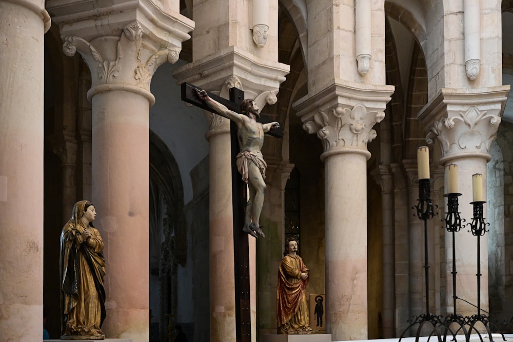 gold statue on white concrete column