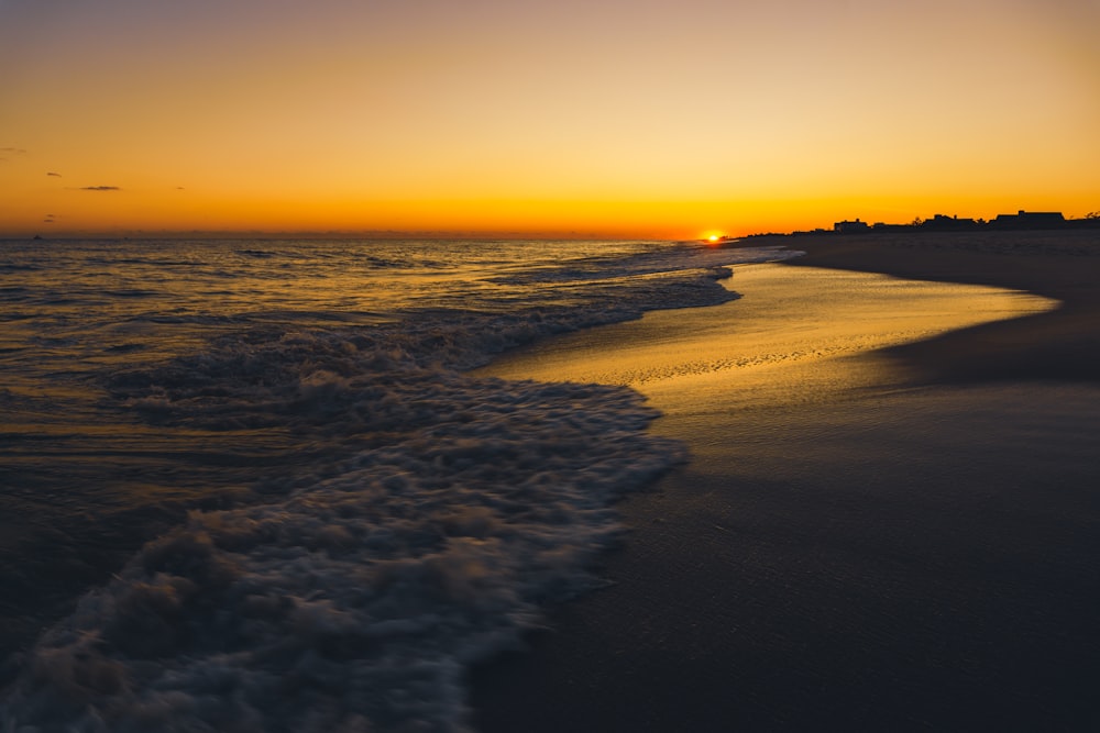 body of water during sunset