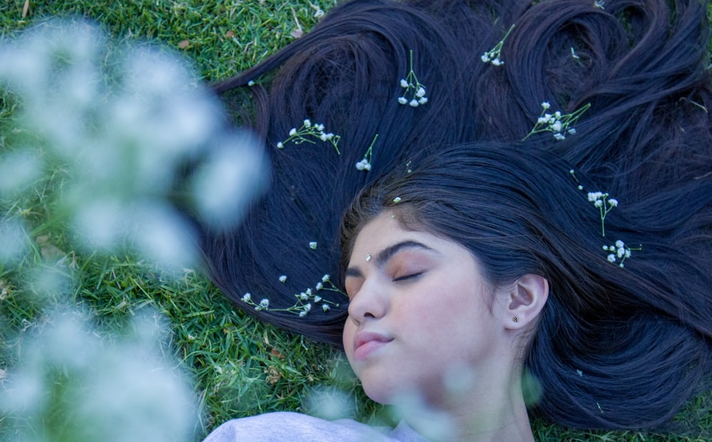 woman lying on green grass field