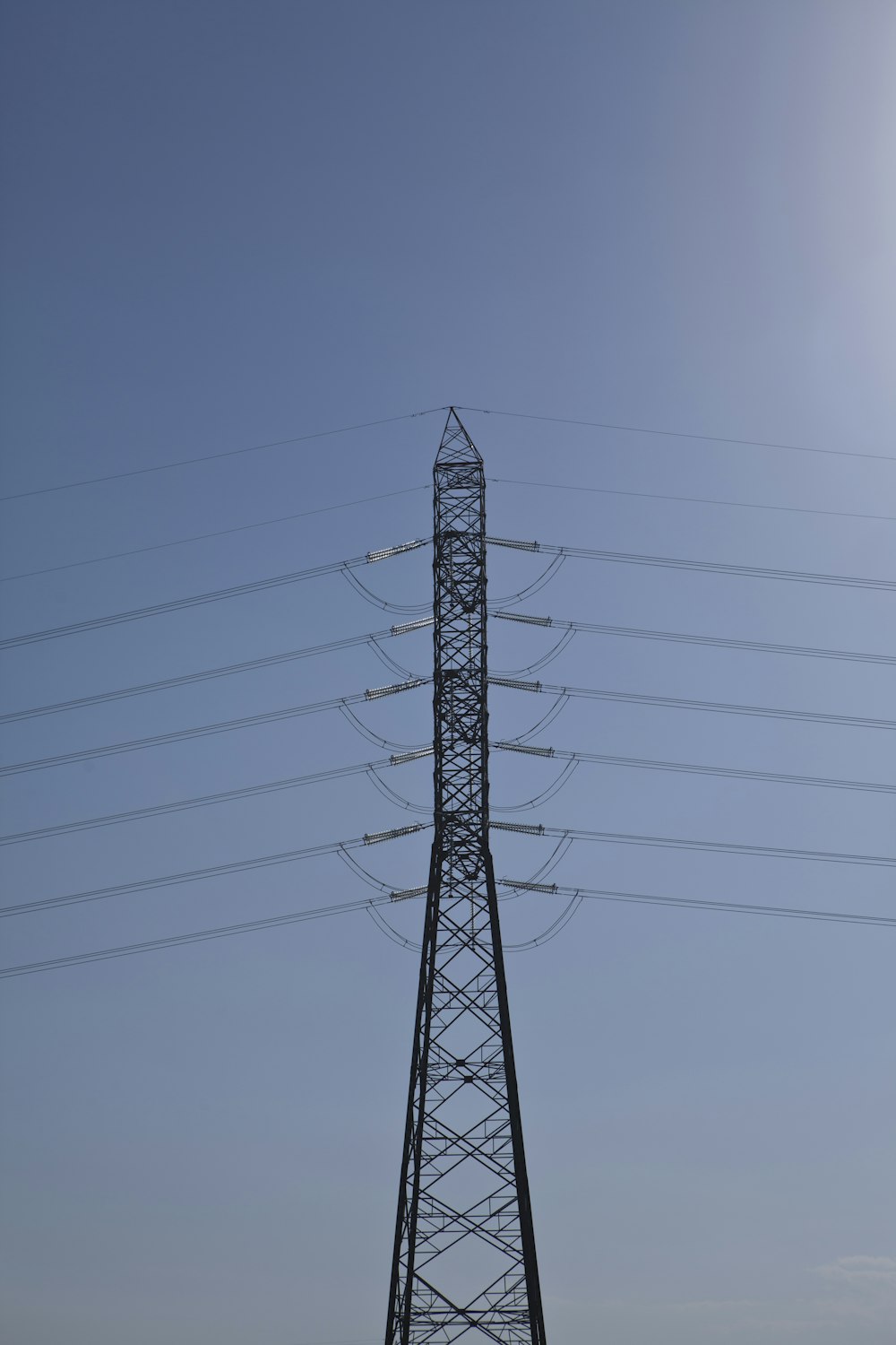 black electric tower under gray sky