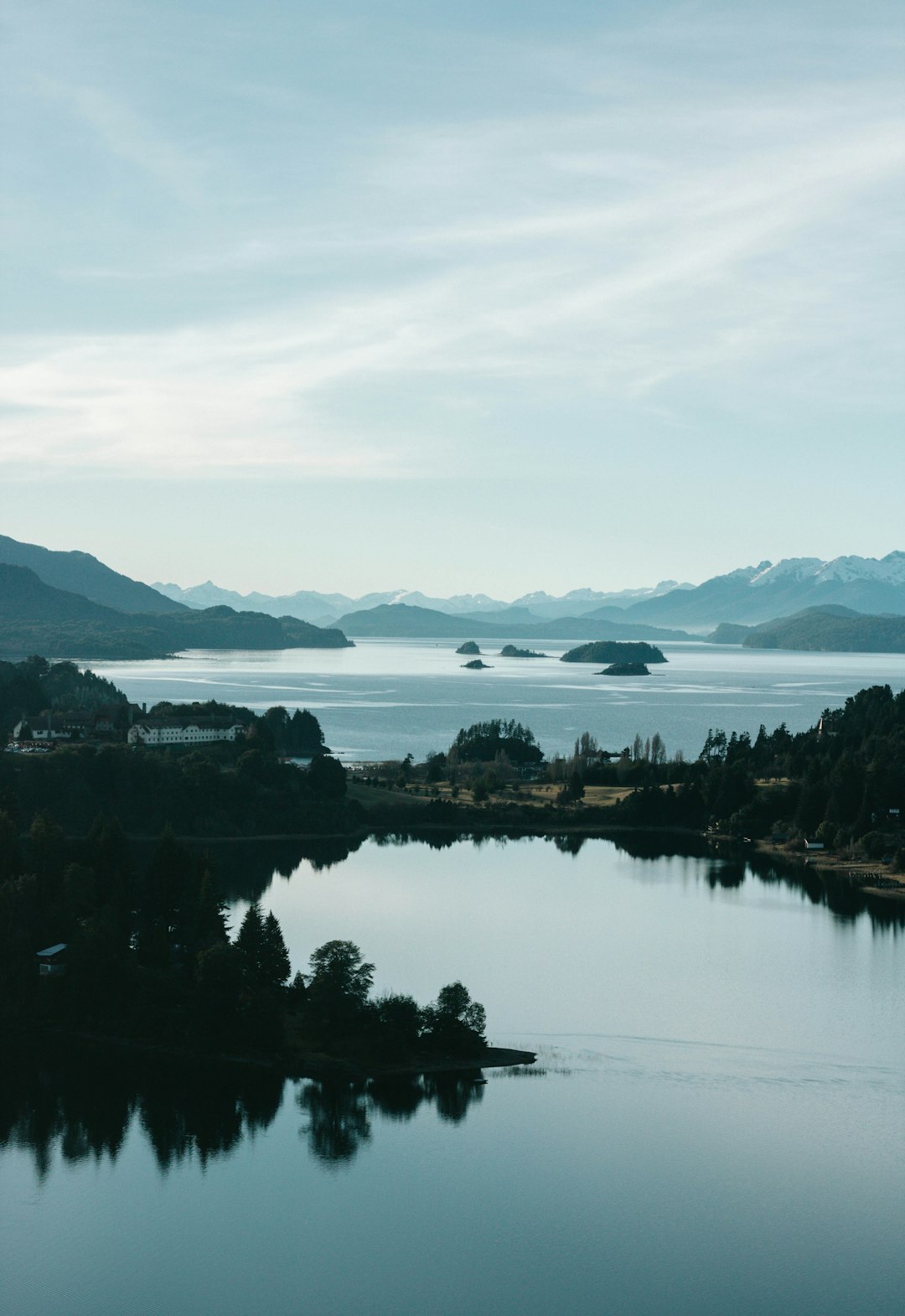 body of water near mountain during daytime