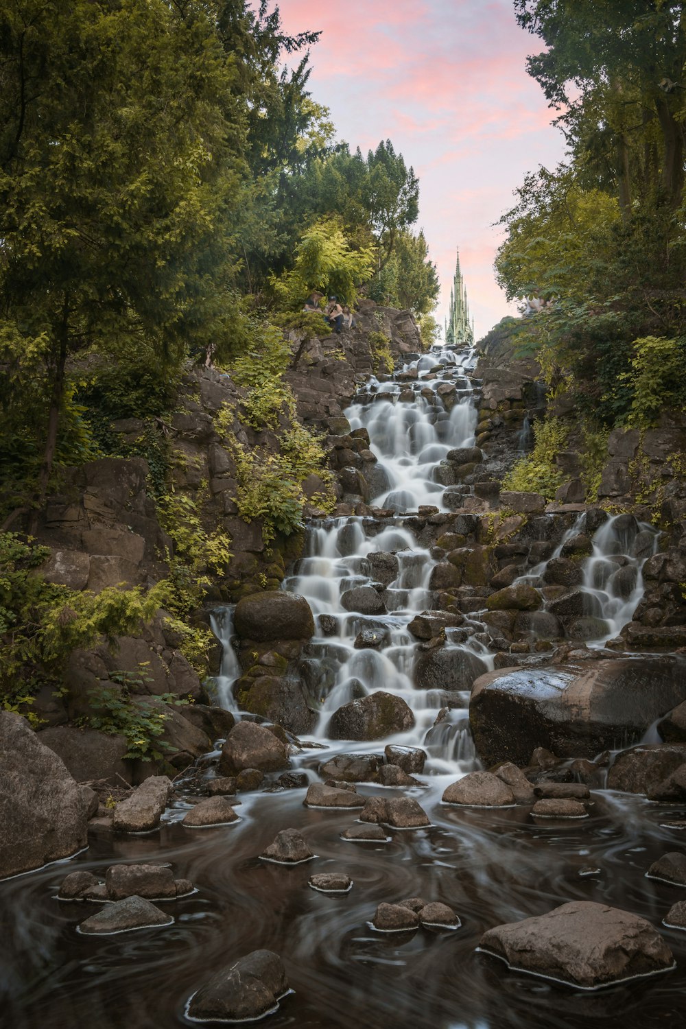 waterfalls in the middle of the forest during daytime