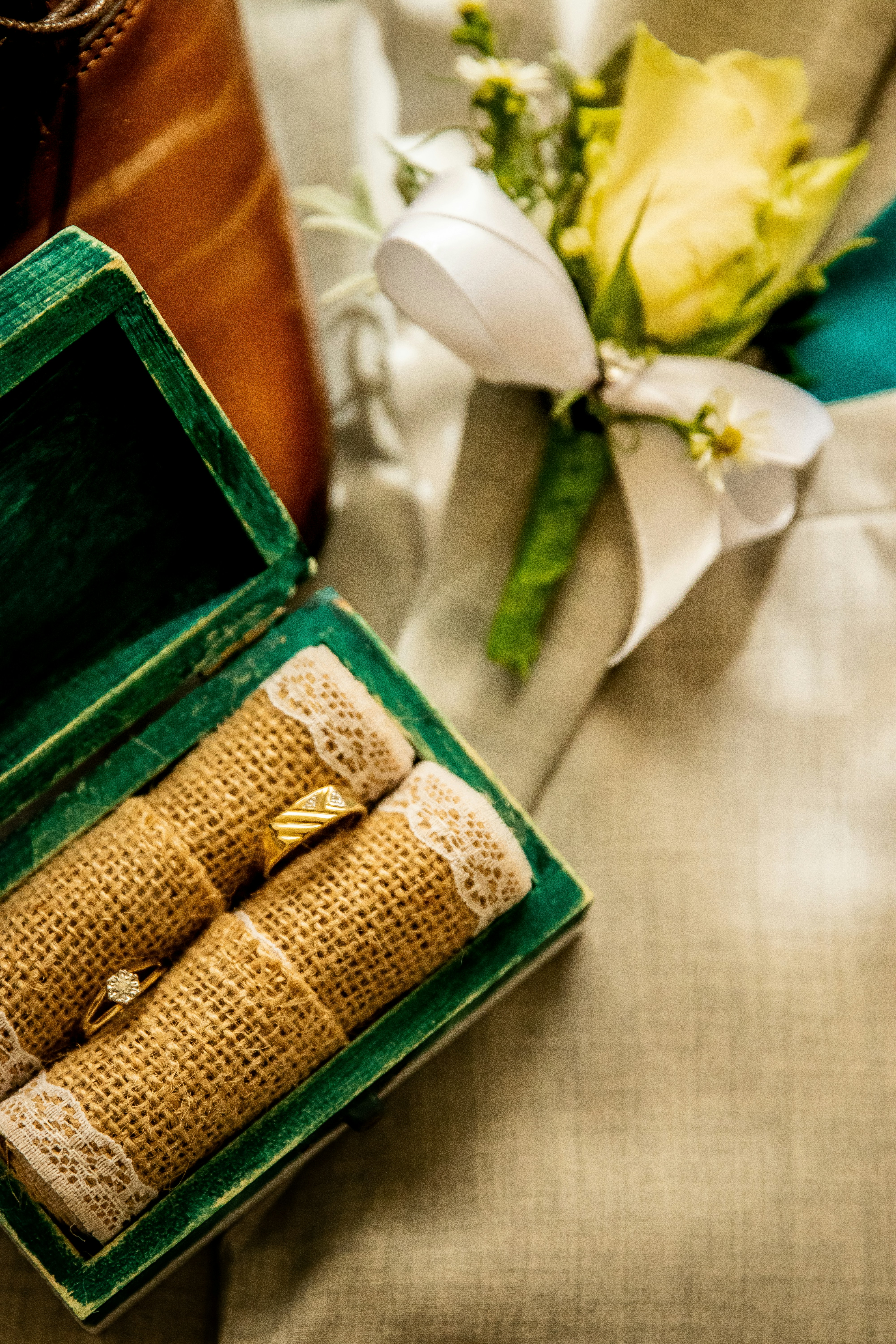 gold and silver ring in green box