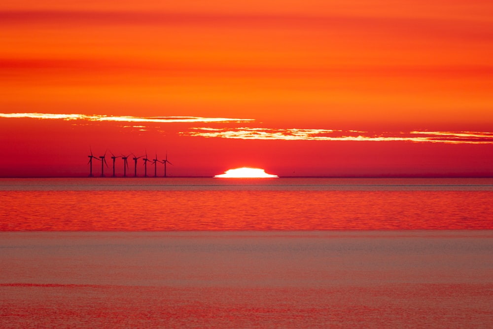 silhouette of bridge on sea during sunset