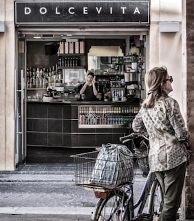 woman in white and brown long sleeve shirt and blue denim jeans holding shopping cart