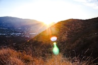 Sunset casting warm light over mountain ridges and trail runners.