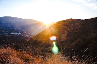 Sunset casting warm light over mountain ridges and trail runners.