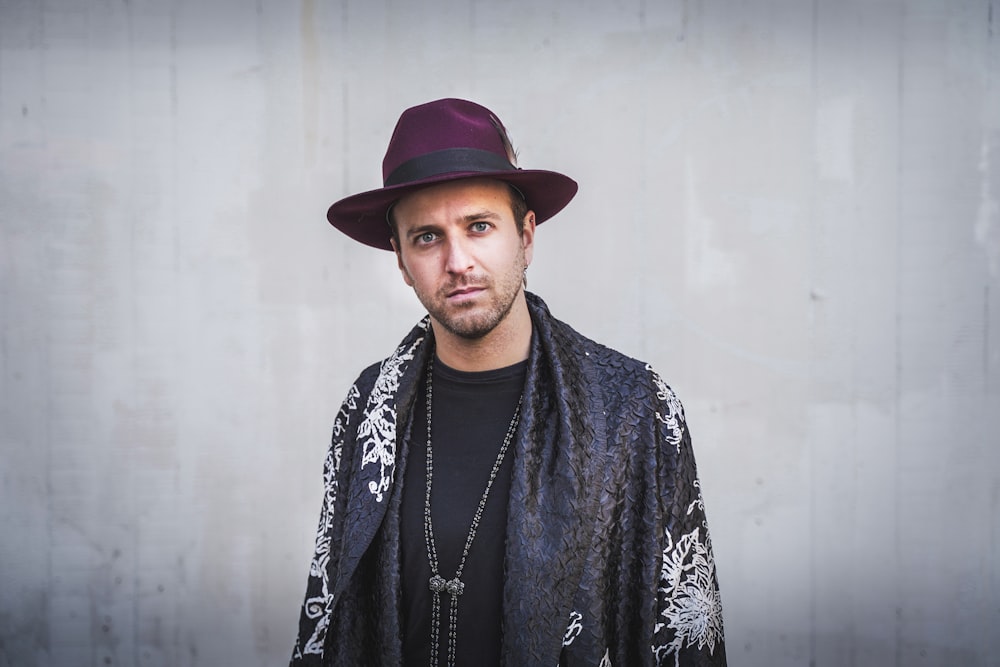 man in black and white floral robe wearing red hat