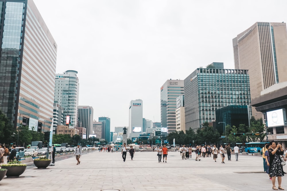 people walking on street near high rise buildings during daytime