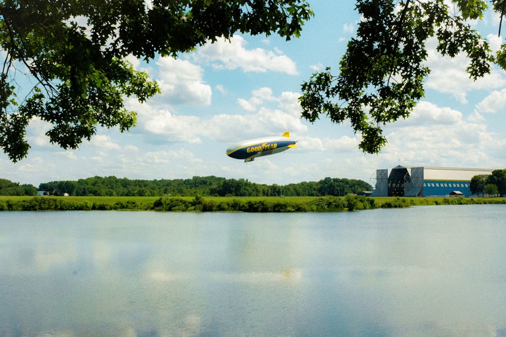 green trees beside lake under blue sky during daytime