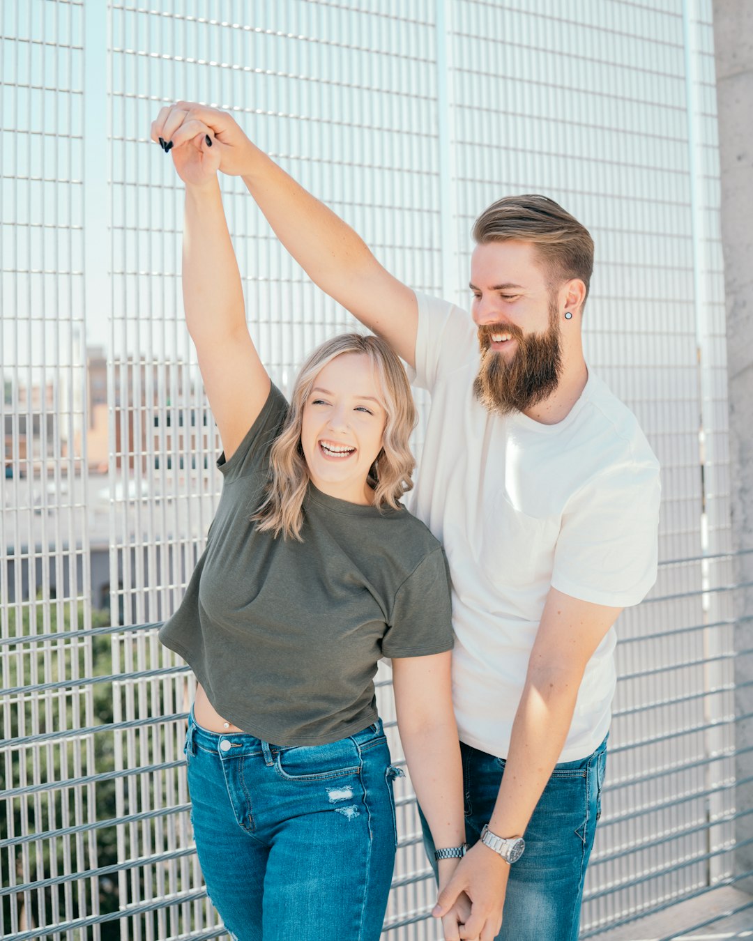 man in white crew neck t-shirt standing beside woman in gray t-shirt