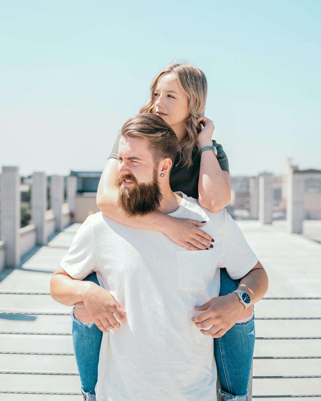 woman in white shirt hugging woman in blue denim jeans