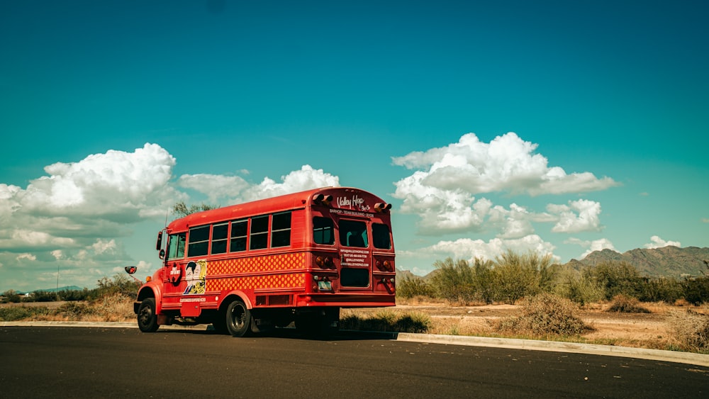 red bus on road during daytime