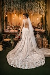 woman in white wedding dress standing beside red roses