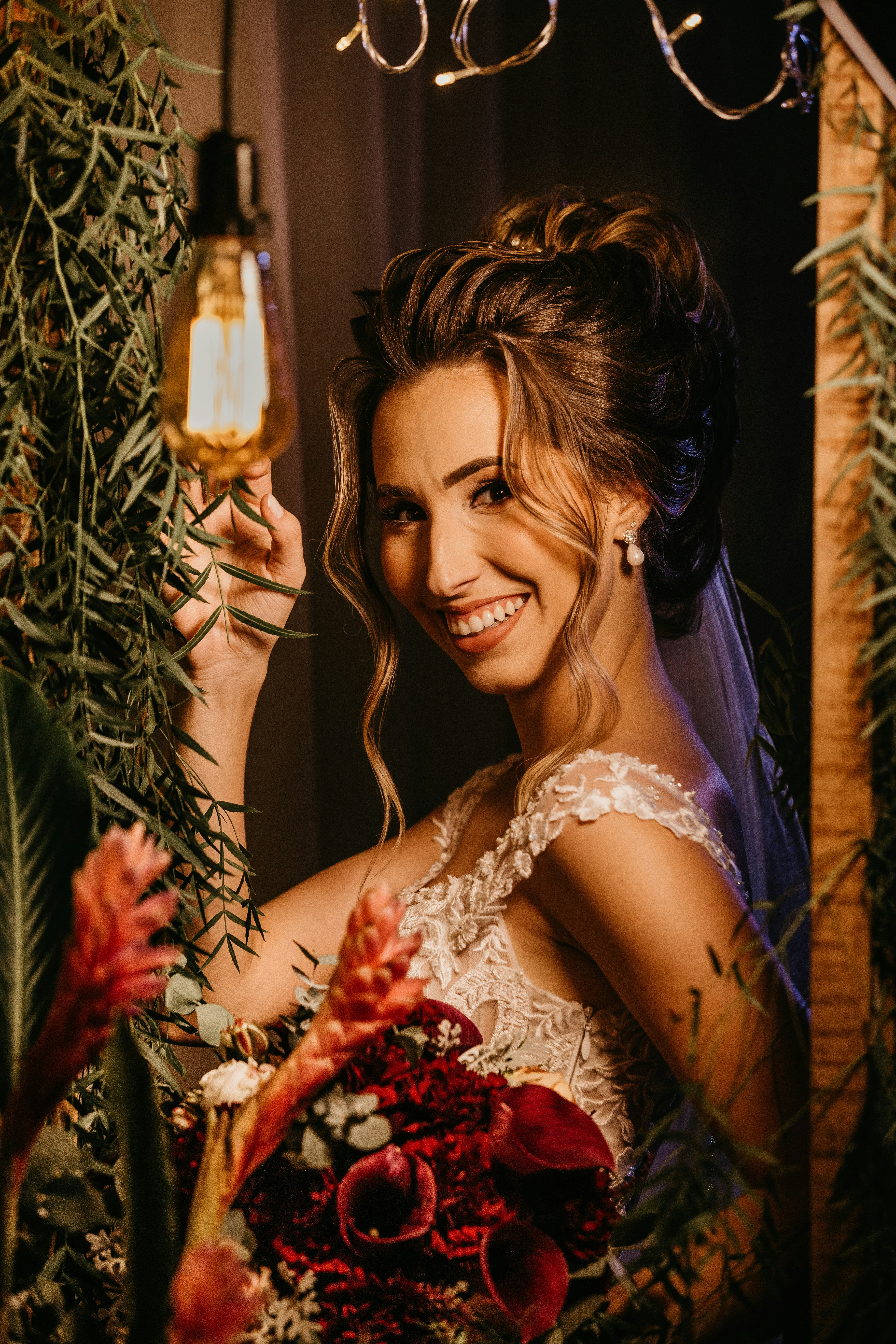 woman in white floral lace dress smiling