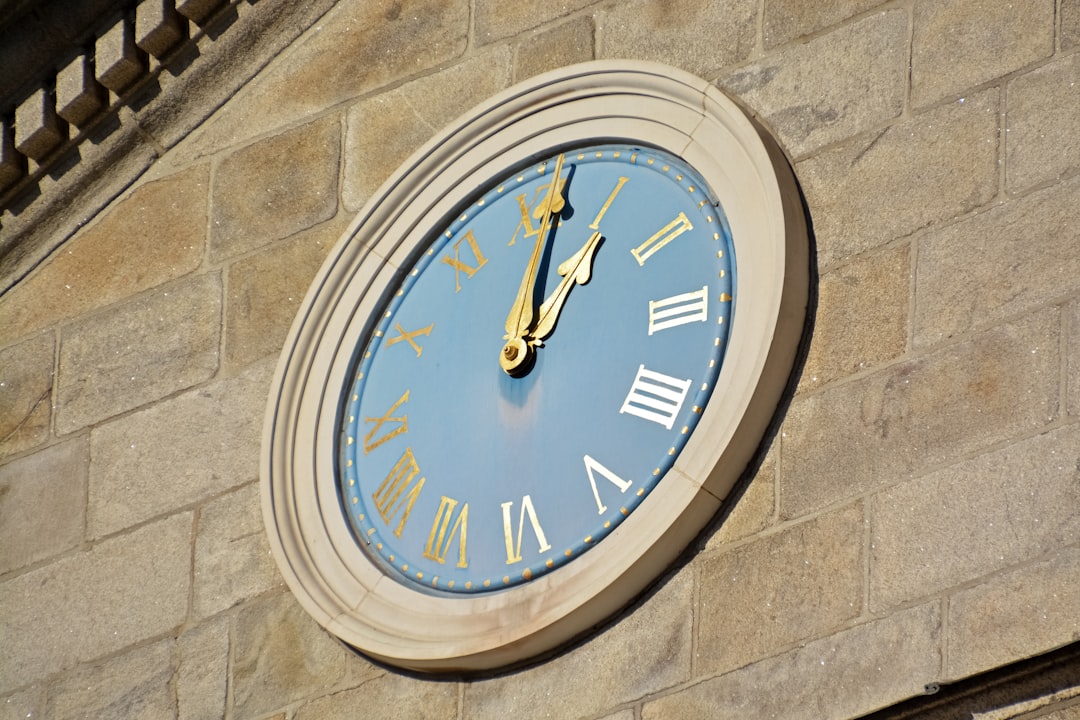 brown wooden round analog wall clock