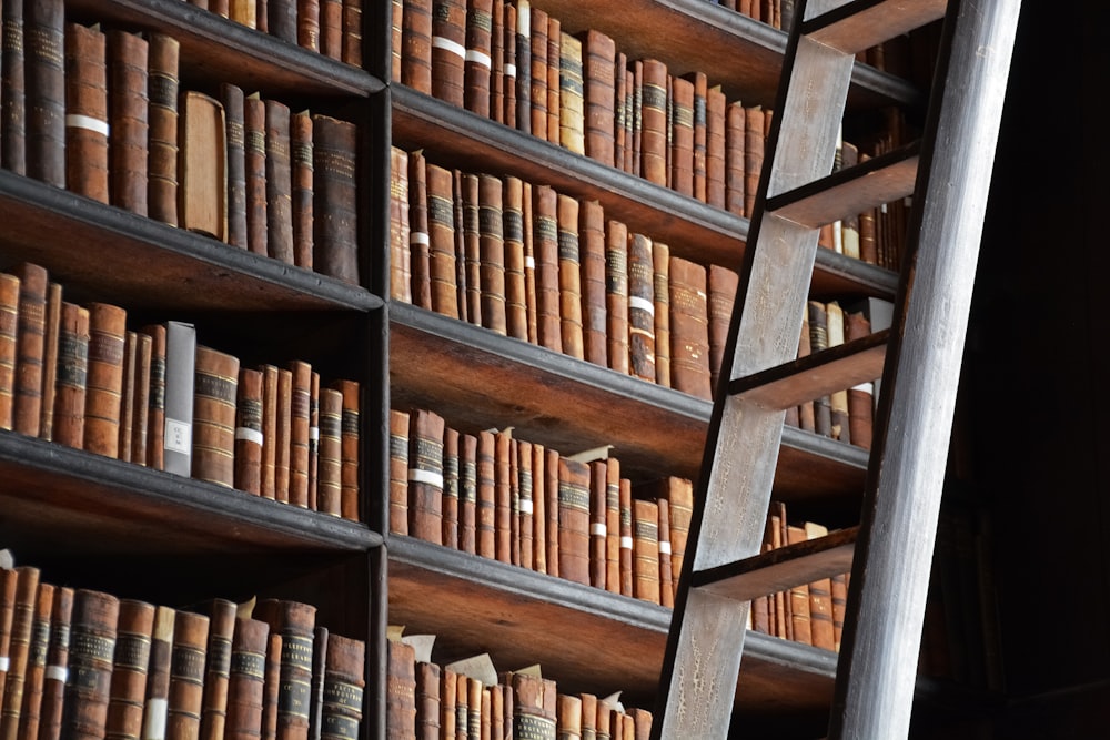 brown wooden book shelves in close up photography