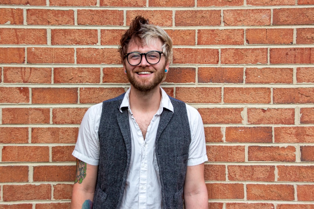 man in blue vest and white button up shirt wearing eyeglasses