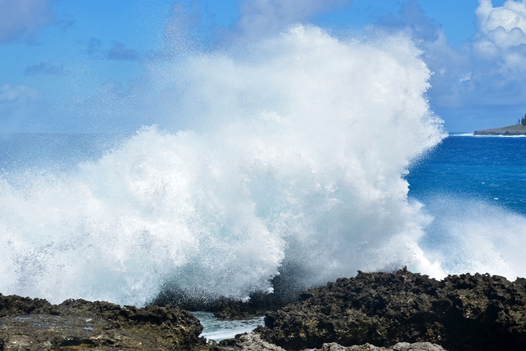 ocean waves crashing on rocky shore during daytime