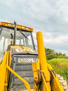 Close-up of a Caterpillar excavator being loaded onto a shipping container.