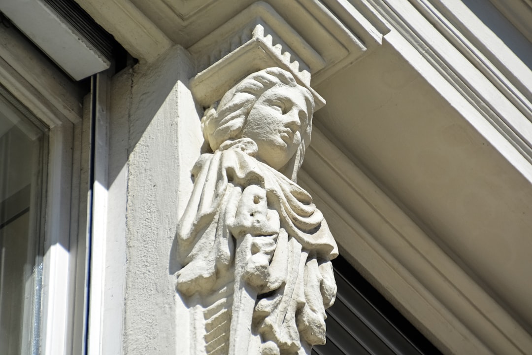 white concrete statue of man