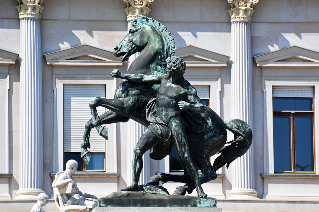 man riding horse statue near white building