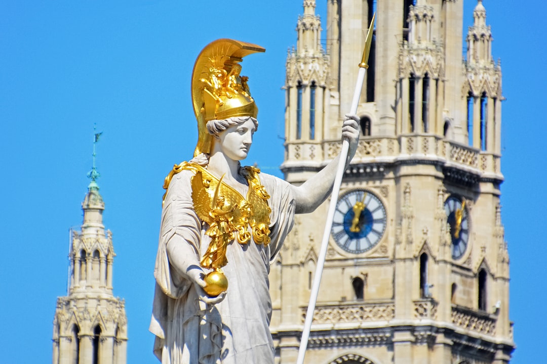 gold statue of man holding gold trophy