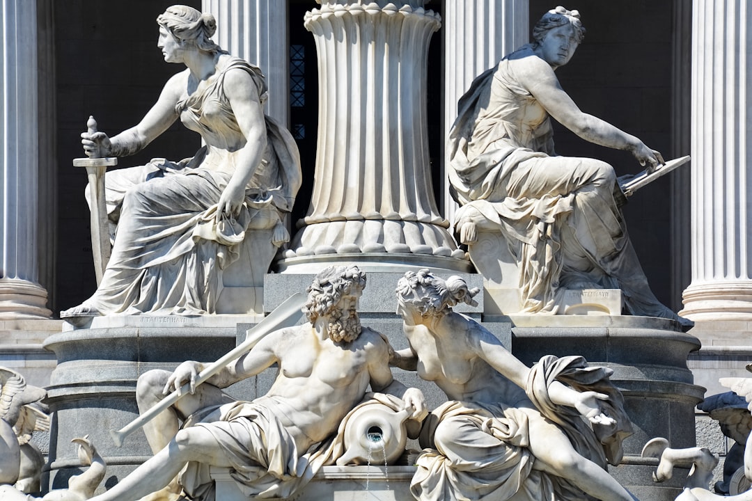 white concrete statue of man and woman