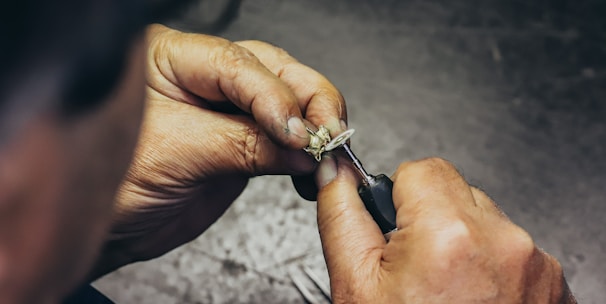person holding silver and black hand tool