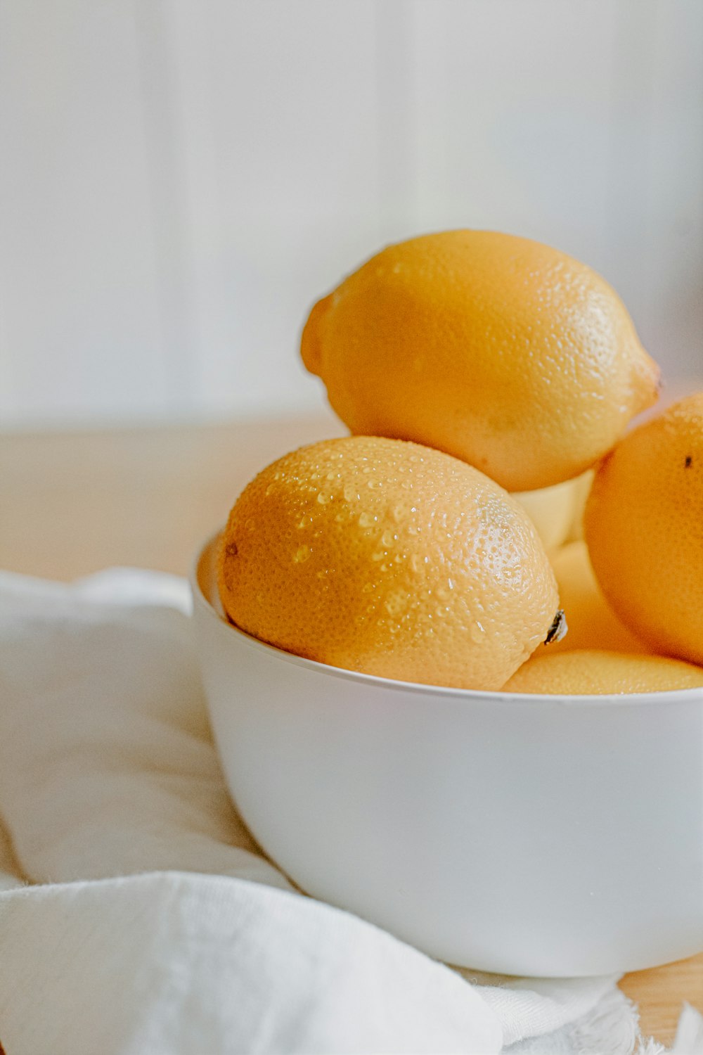 yellow citrus fruit on white ceramic bowl